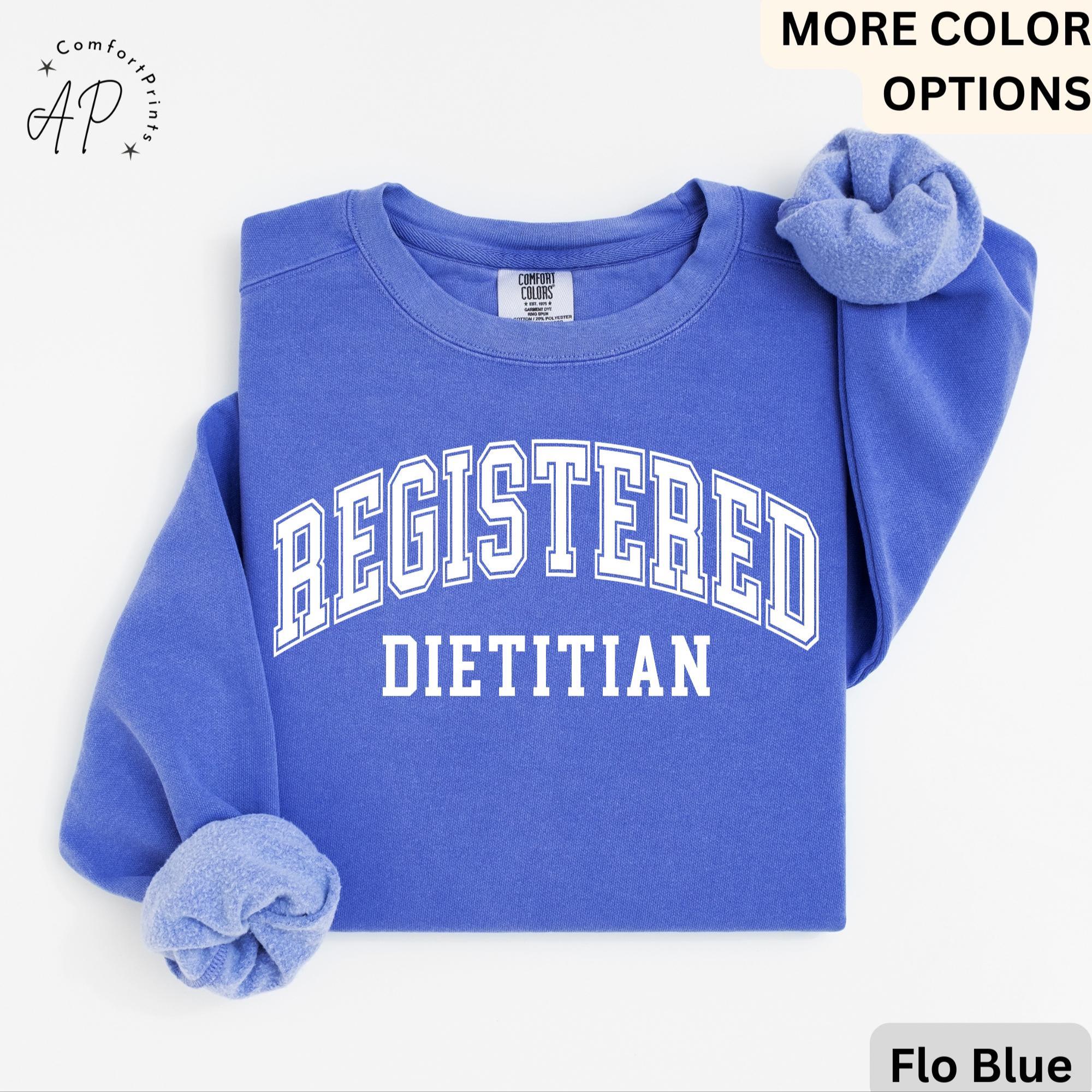 May include: A blue sweatshirt with the text "REGISTERED DIETITIAN" in white.
