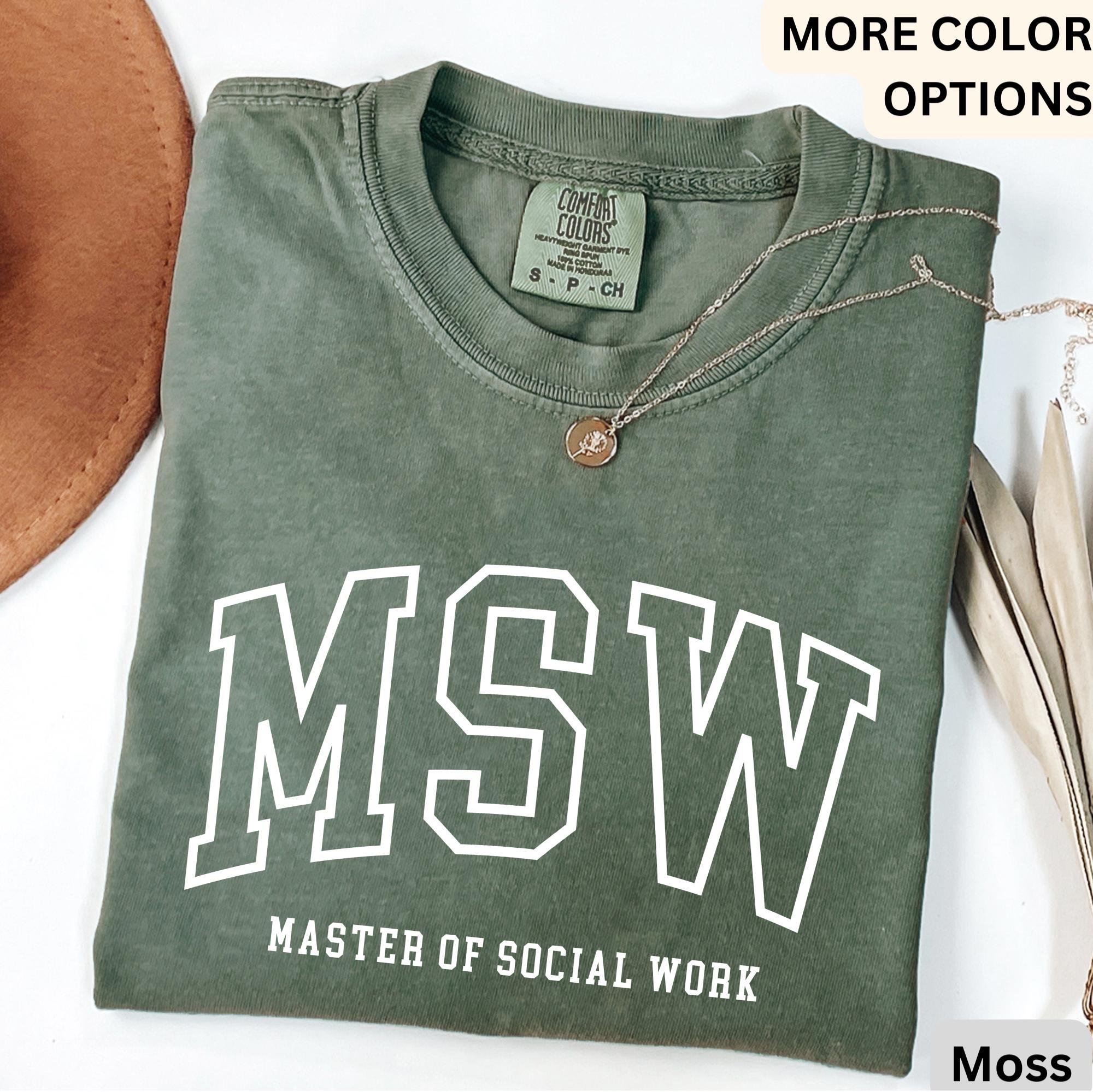 May include: A moss green t-shirt with the text "MSW" in white outlined letters. Below the letters is the text "Master of Social Work".