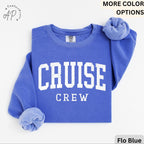 May include: Flo Blue sweatshirt with the words "CRUISE CREW" in white block letters. The sweatshirt is folded, with the sleeves cuffed. The Comfort Colors label is visible. The words "MORE COLOR OPTIONS" are in the top right corner.